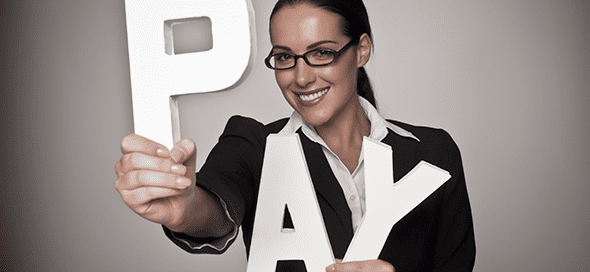 Woman holding up the letters P, A, Y.