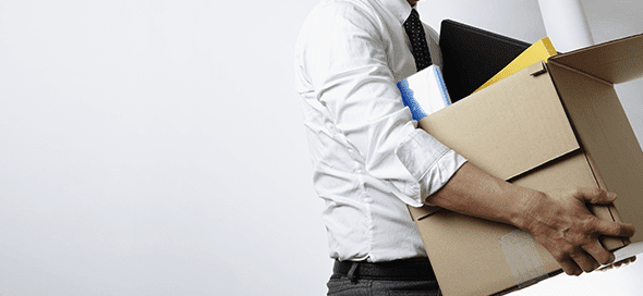 Man holding a box full of his belongings