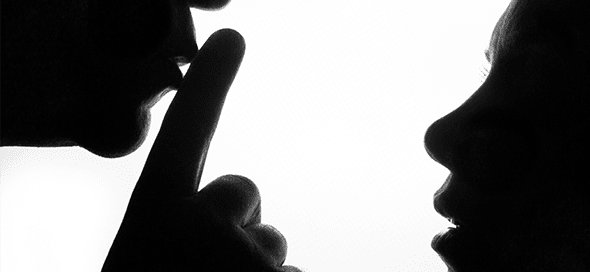 Silhouette of male figure shushing a female figure.